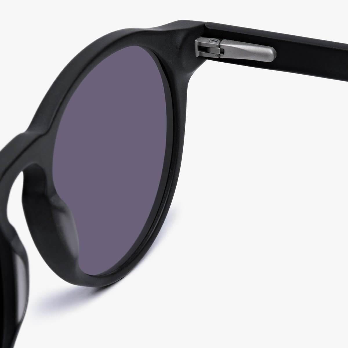Close-up of black sunglasses with round lenses