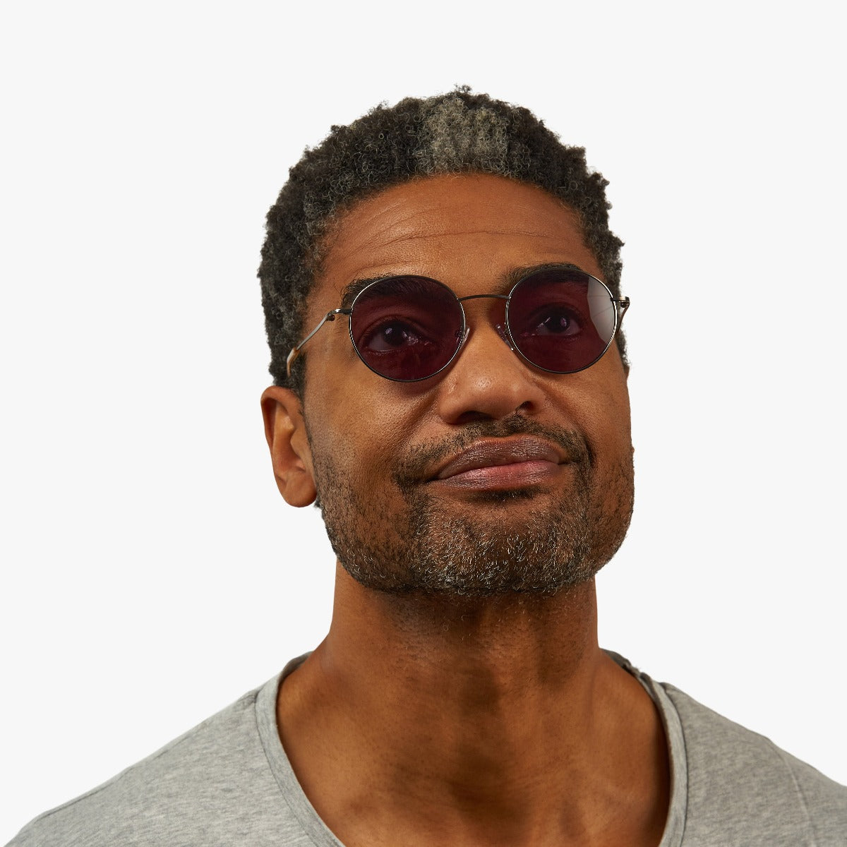 Person wearing Tromsø Gun glasses with dark lenses